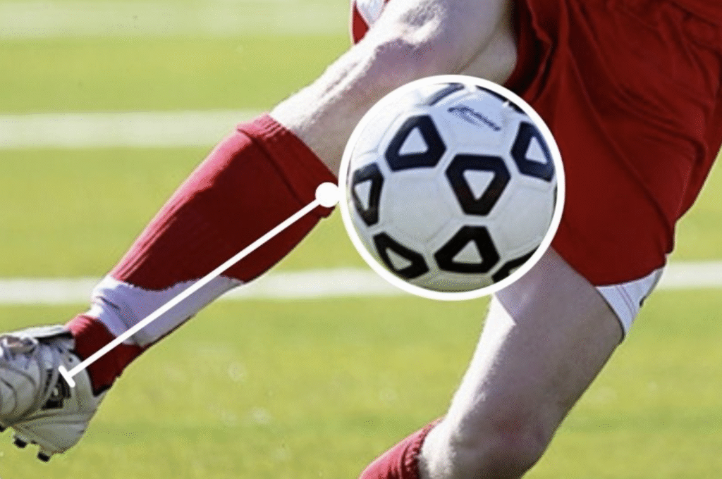 Football player demonstrating proper first touch technique while receiving the ball during training