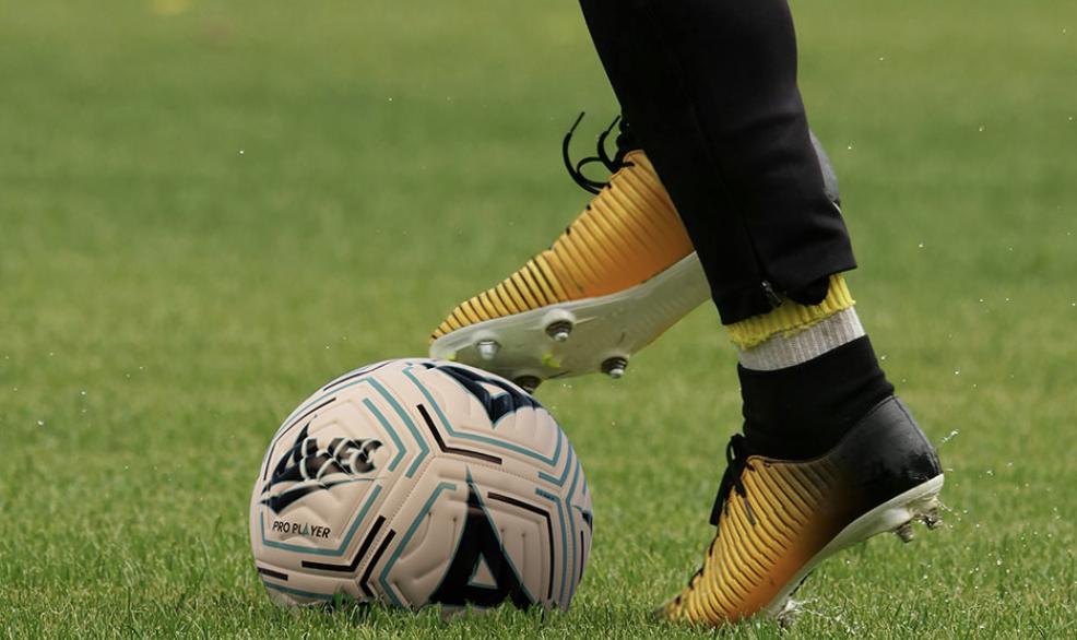 Close-up of football player's feet controlling ball during training showing proper footwork technique